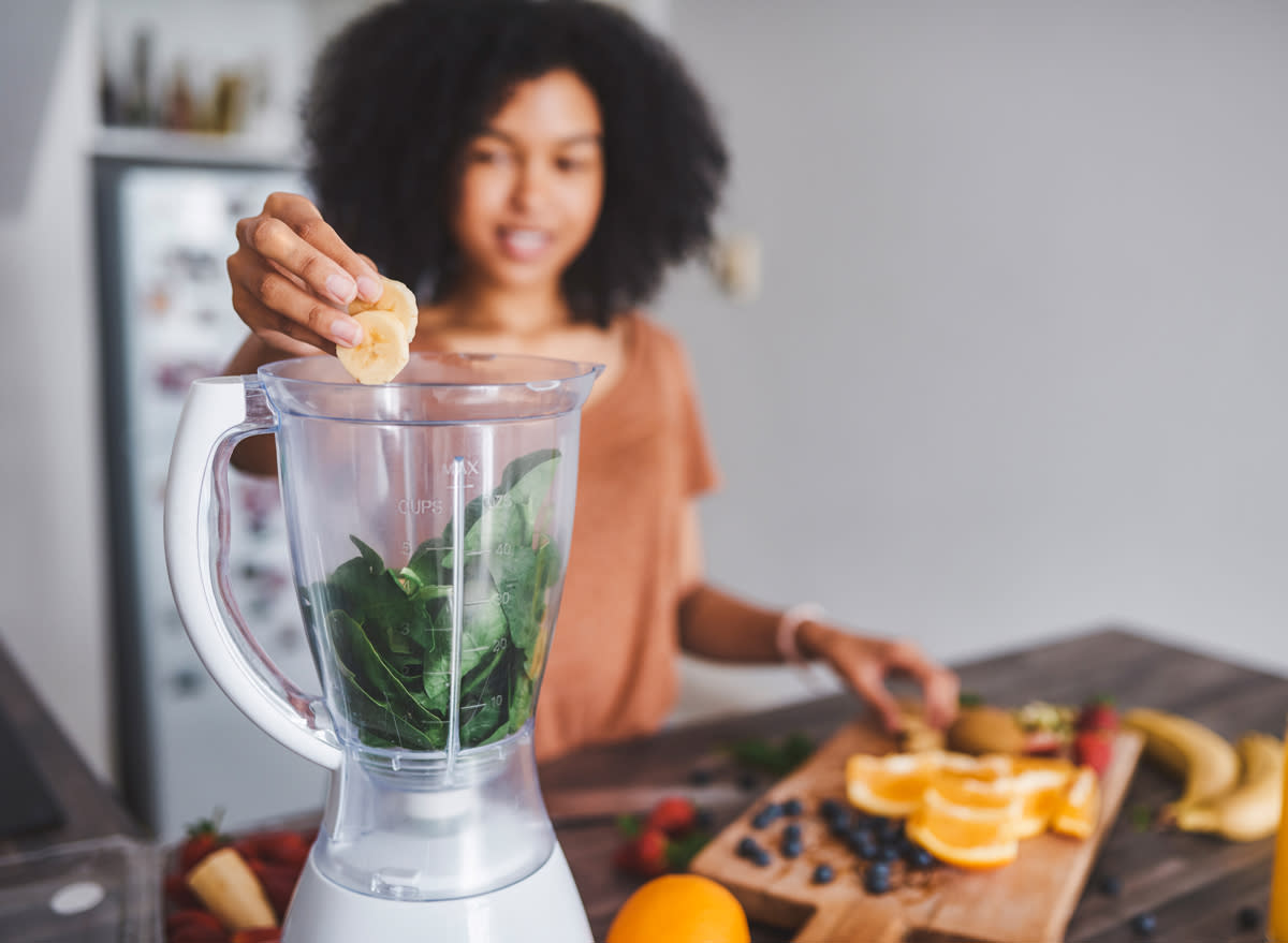 making spinach banana smoothie in a blender