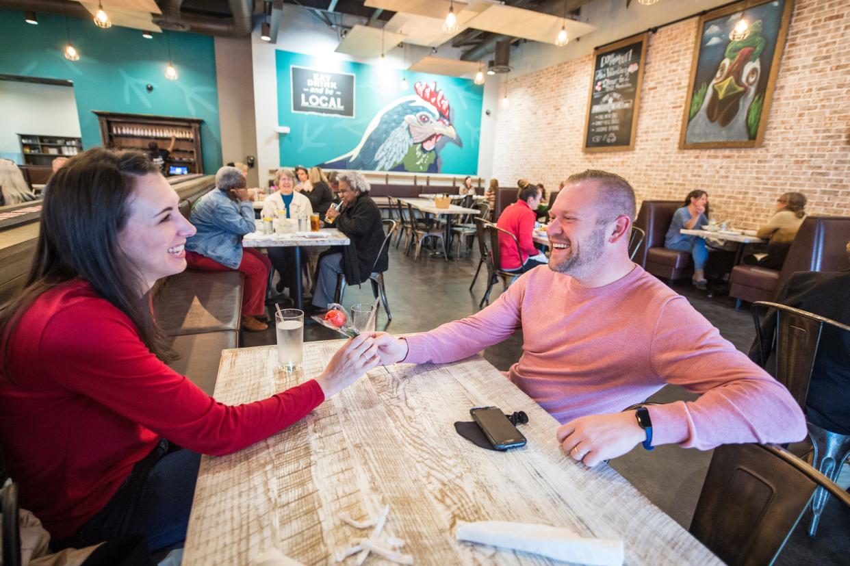 FILE - Thomas Dearden hands a rose to his wife, Becky Dearden while they have lunch at the Frog and the Hen in Augusta on Friday, Feb. 11, 2021. Yelp has ranked it as one of the best brunch spots in the area.