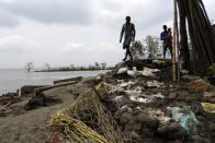 This May 22, 2020 photo shows villagers inspecting the damage after Cyclone Amphan struck Deulbari village, in South 24 Parganas district in the Sundarbans, West Bengal state, India. The cyclone that struck India and Bangladesh last month passed through the Sundarbans, devastating the islands that are home to one of the world’s largest mangrove forests and is a UNESCO world heritage site. (Samrat Paul via AP)