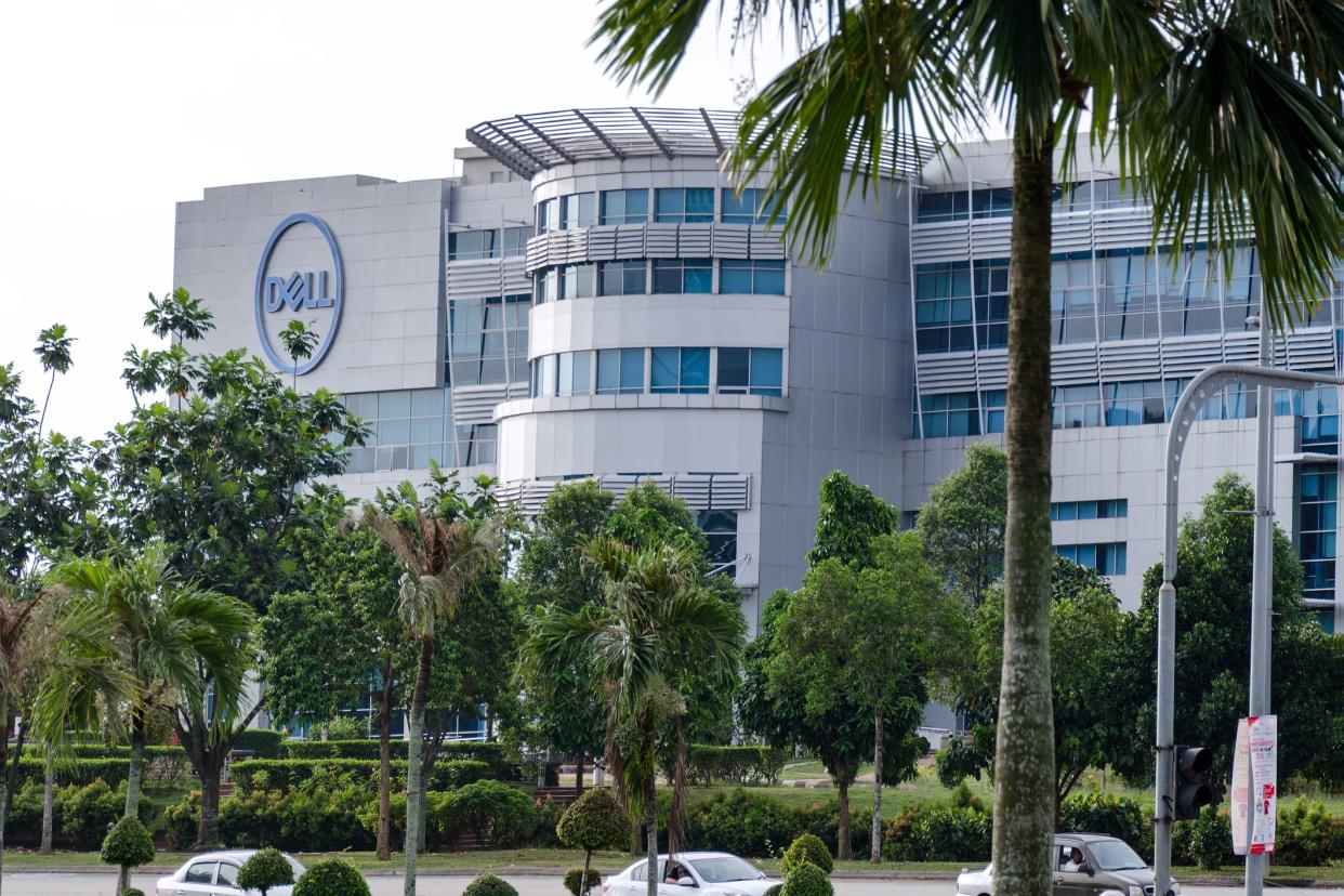 Malaysia, Cyberjaya, 2018-03-31: Exterior view of Dell Technologies office building, on street with palm and green trees.