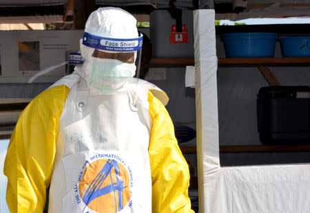 FILE PHOTO: A medical worker wears a protective suit as he prepares to administer Ebola patient care at The Alliance for International Medical Action (ALIMA) treatment center in Beni, North Kivu province of the Democratic Republic of Congo September 6, 2018. REUTERS/Fiston Mahamba/File Photo