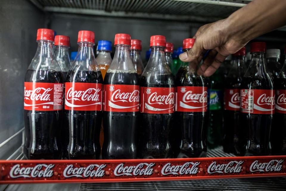 Coca-Cola Co. beverages are placed on a shelf in a store in New Delhi, India, on Sunday, July 29, 2012. India refrained from joining peers in lowering interest rates, focusing instead on curbing inflation as a power-grid shutdown exposed infrastructure deficiencies that keep prices elevated and limit policy options. Photographer: Sanjit Das/Bloomberg