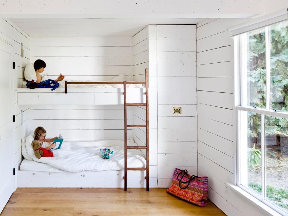 In the tiny house, custom bunk beds and a pull-out closet help optimize the space.