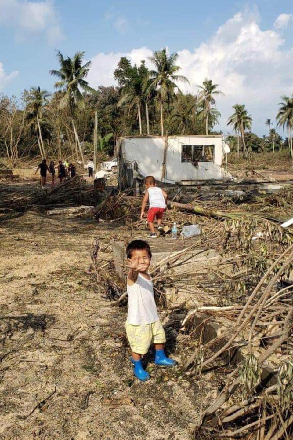 Children in Tonga’s capital amid debris left in the tsunami’s wake (Consulate of the Kingdom of Tonga)
