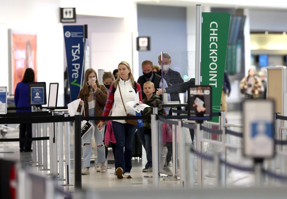 Airline passengers prepare to enter a security checkpoint at San Francisco International Airport on April 19, 2022, in San Francisco.