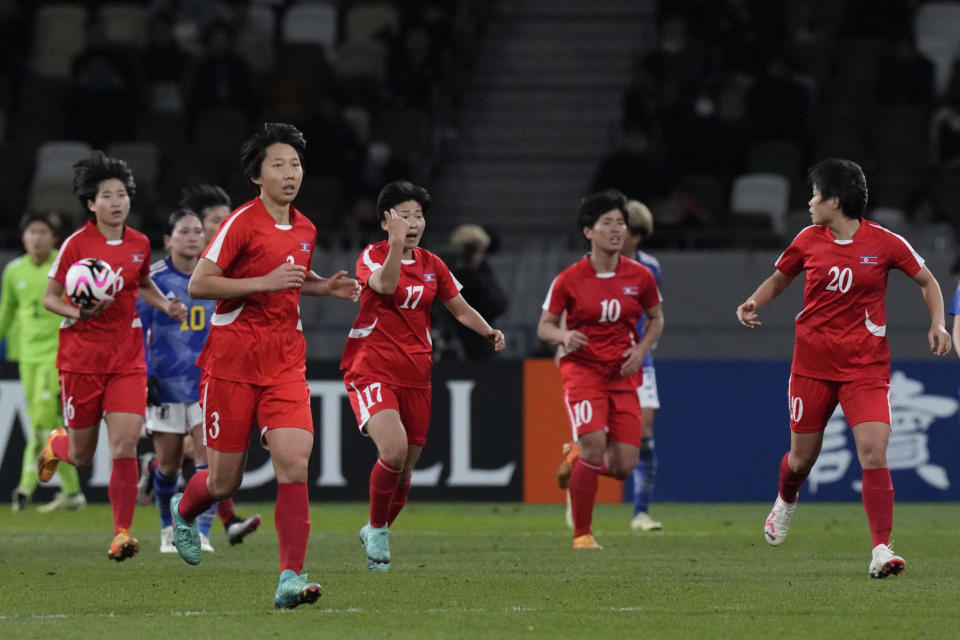 North Korean players celebrate their first goal during the final qualifier for the Paris Olympic women's football tournament between Japan and North Korea at the National Stadium Wednesday, Feb. 28, 2024, in Tokyo. (AP Photo/Eugene Hoshiko)