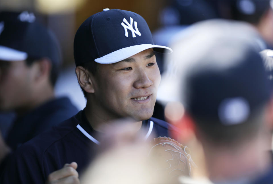 New York Yankees pitcher Masahiro Tanaka reacts with teammates after pitching the fifth inning in an exhibition baseball game against the Philadelphia Phillies Saturday, March 1, 2014, in Tampa, Fla. (AP Photo/Charlie Neibergall)