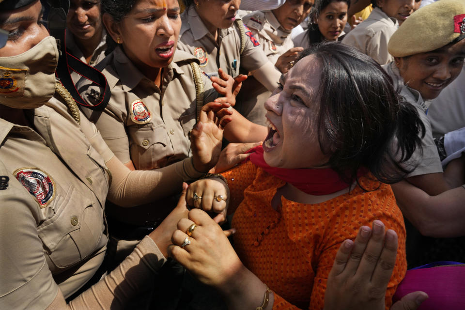A member of Aam Admi Party, or Common Man's Party, screams as she is detained by the police during a protest against the arrest of their party leader Arvind Kejriwal in New Delhi, India, Tuesday, March 26, 2024. Indian police have detained dozens of opposition protesters and prevented them from marching to Prime Minister Narendra Modi’s residence to demand the release of their leader and top elected official of New Delhi who was arrested last week in a liquor bribery case. (AP Photo/Manish Swarup)