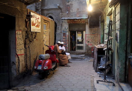 Al-Azhar students sit near a bookshop that sells Islamic and reference books for Al-Azhar students near the Al-Azhar mosque in Cairo, Egypt, May 18, 2015. REUTERS/Asmaa Waguih