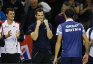 Tennis - Great Britain v United States of America - Davis Cup World Group First Round - Emirates Arena, Glasgow, Scotland - 6/3/15 Great Britain's James Ward (R) celebrates victory with Andy Murray and Jamie Murray (L) Action Images via Reuters / Andrew Boyers Livepic