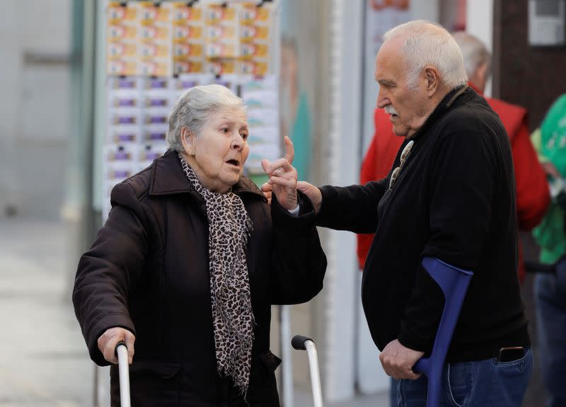 Pensioners chat in a street in Ronda