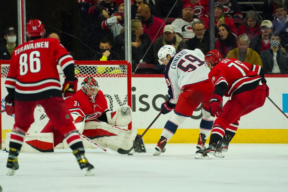 Jan 13, 2022; Raleigh, North Carolina, USA;  Columbus Blue Jackets right wing Yegor Chinakhov (59) scores a goal past Carolina Hurricanes goaltender Frederik Andersen (31) during the third period at PNC Arena. Mandatory Credit: James Guillory-USA TODAY Sports