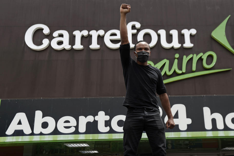 A man shouts "Black lives matter" during a protest against the murder of Black man João Alberto Silveira Freitas, which occurred at a different Carrefour supermarket the night before, outside a Carrefour supermarket in Brasilia, Brazil, Friday, Nov. 20, 2020, which is National Black Consciousness Day in Brazil. Freitas died after being beaten by supermarket security guards in the southern Brazilian city of Porto Alegre, sparking outrage as videos of the incident circulated on social media. (AP Photo/Eraldo Peres)