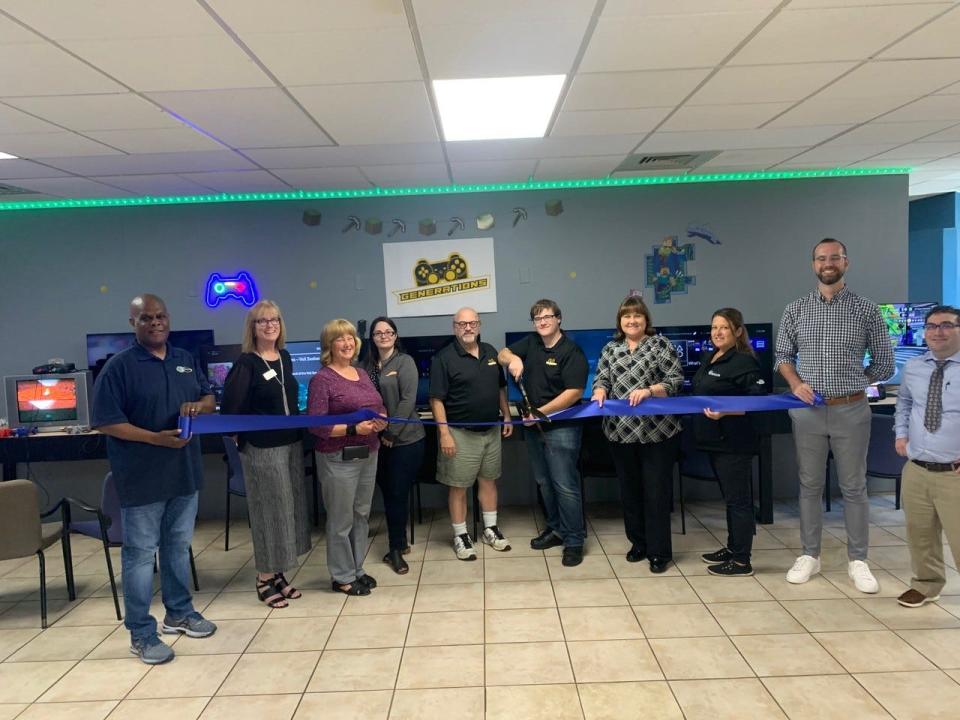 From left to right are David Robart, Business Communications of Maine; Sharla Rollins, First
Seacoast Bank; Janet Oliver, Unitil; Kristin Travers, SERVPRO of Dover – Rochester; James
Albion, Generations Arcade; Matthew Albion, cutting the ribbon for Generations Arcade; Mary
Henderson, Bank of New Hampshire; Jenn Marsh, Rochester Economic Development; Matt
Wyatt, City of Rochester; and Ben Coakley, Greater Rochester Chamber of Commerce.