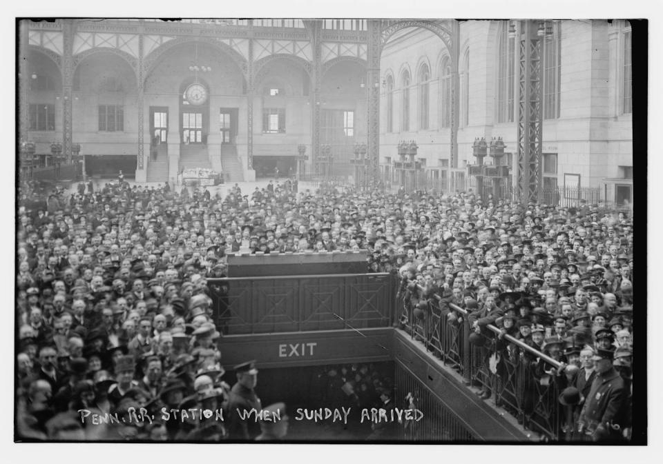 Throngs of people fill the central hall at New York's old Penn station.