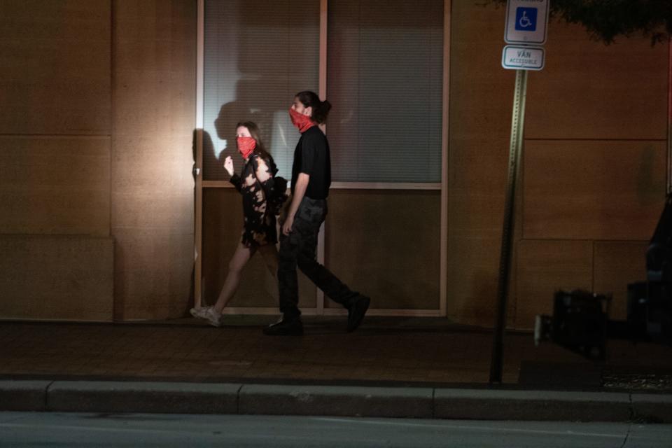 A spotlight is pointed on protesters walking along Kansas Ave in between 5th St. and 6th Ave by Kansas Highway Patrol officers after a protest on June 1, 2020.