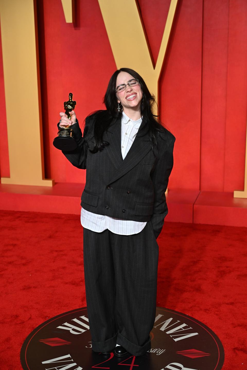 Image may contain: Billie Eilish, Fashion, Adult, Person, Accessories, Glasses, Face, Head, Clothing, Formal Wear, and Suit