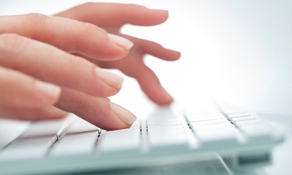 Women’s hands on white computer keyboard