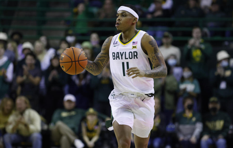 WACO, TX - JANUARY 15: James Akinjo #11 of the Baylor Bears handles the ball against the Oklahoma State Cowboys in the first half at the Ferrell Center on January 15, 2022 in Waco, Texas. (Photo by Ron Jenkins/Getty Images)