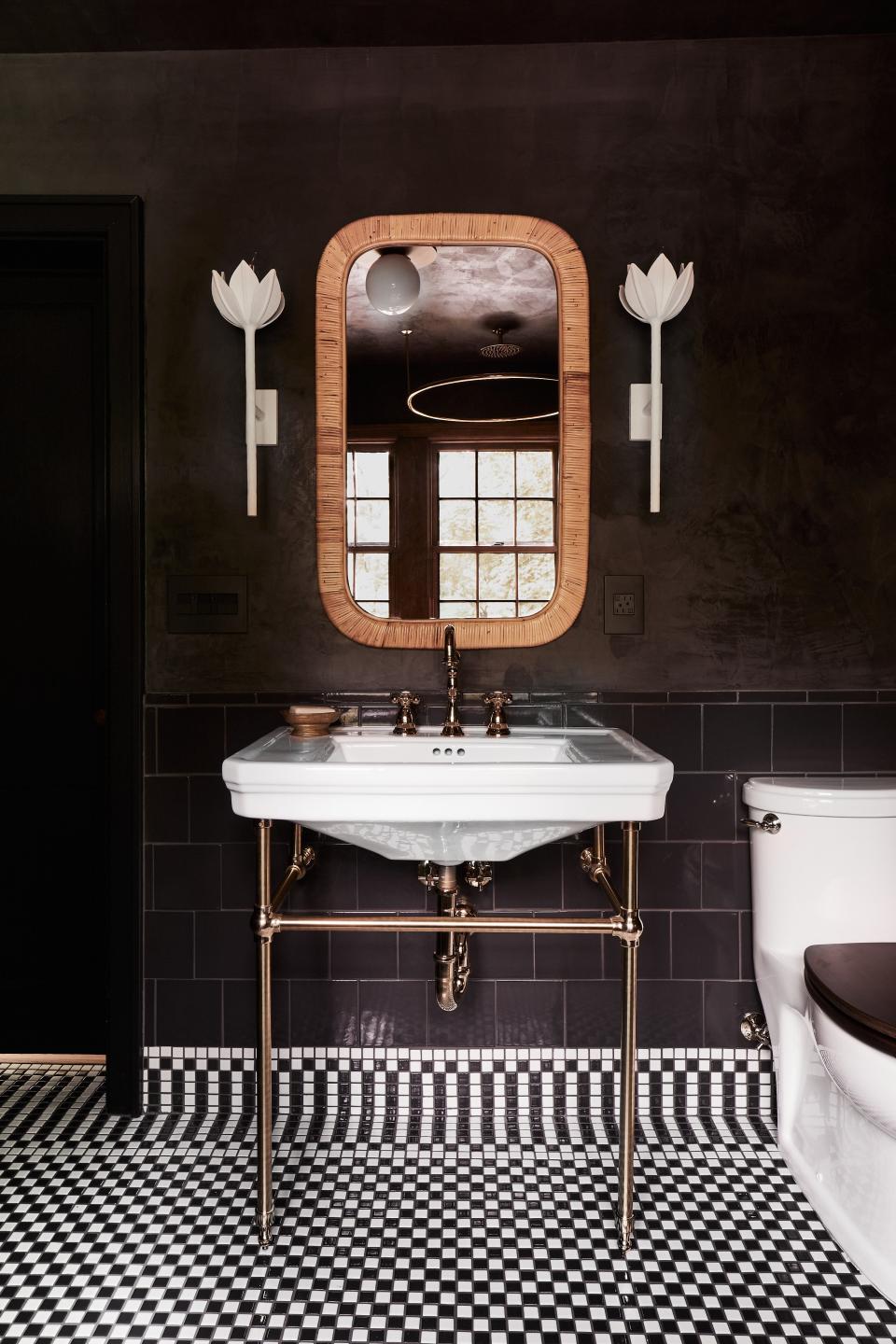 In Carlton’s sun-splashed Nashville bathroom, Portola Paint’s Roman Clay deepens the dimension of the walls, accented with tulip-shaped Circa Lighting sconces and a checkerboard tile floor and border designed by Sherman Samuel. Getting Carlton—and her husband—on board with the black-and-white pattern took some convincing, but “then she loved it.”