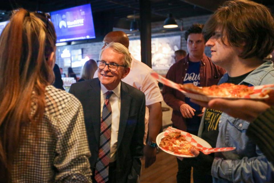 Ohio Gov. Mike DeWine talks with prospective voters over pizza at the Stubborn Brother restaurant in Toledo, Ohio, Sunday, May 1, 2022. (Phillip L. Kaplan/The Blade via AP)