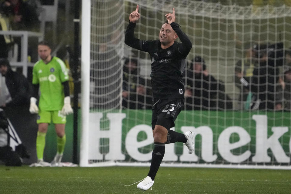 Nashville SC defender Taylor Washington (23) celebrates after scoring a goal against CF Montreal goalkeeper Jonathan Sirois, left, in the second half of an MLS soccer game, Saturday, March 11, 2023, in Nashville, Tenn. Nashville SC won 2-0. (AP Photo/Mark Humphrey)