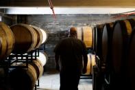 Herman Mihalich walks between barrels of his rye whisky in his distillery in Bristol Pennsylvania