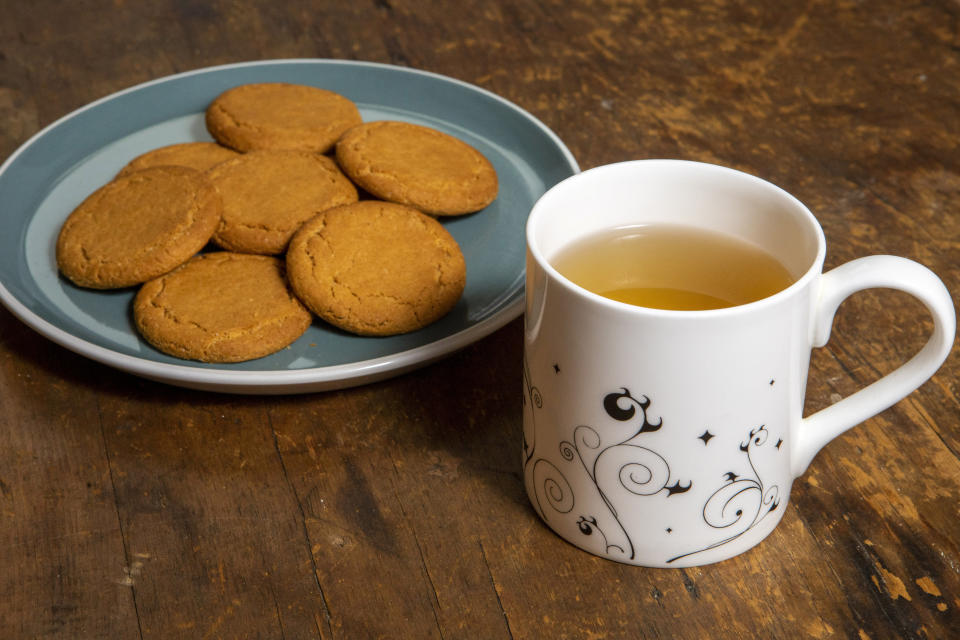 Peppermint tea with Gingernut biscuits.  If you want to get the best out of your fish and chips you should be pairing it with a cup of black tea, says a leading tea expert.  See SWNS story SWBRtea.  Tea Sommelier Angela Pryce has revealed which tea types go best with some of the nationâ€™s favourite meals â€“ suggesting that English breakfast goes brilliantly with roast beef.  She advised lemon drizzle cake can be harmoniously matched with an Earl Grey as their citrus characters complement one another, while green tea combines well with spicy foods because of its refreshing and cleansing texture.  This comes as a survey of 2,000 tea drinkers delved into tea habits across the UK, finding as many as one in five would have a brew with quintessentially British meals like sausage and mash or a jacket potato â€“ and a third love a cuppa with their fish and chips.  The research, commissioned by Clipper, also discovered Brits' more surprising food pairings, finding one in 10 would drink an Earl Grey with a curry and (SWNS)