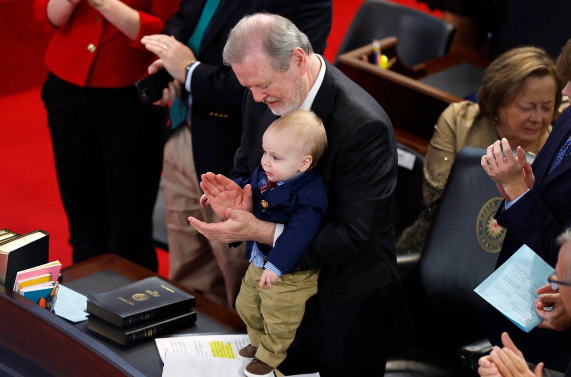 Senate leader Phil Berger holds his grandson Luke Snyder as they stand to celebrate the election of statutory officers during the opening session of the N.C. Senate Wednesday, Jan. 11, 2023.