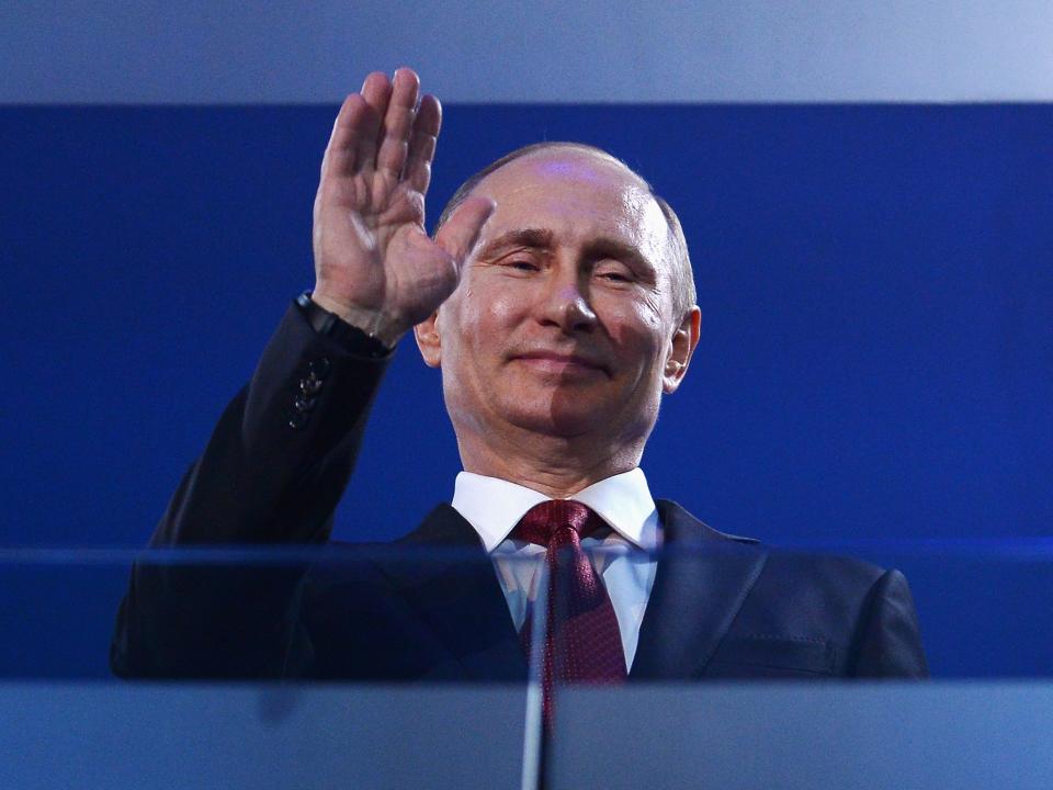 Russia President Vladimir Putin waves.
