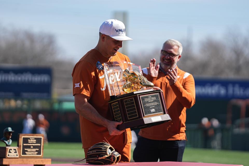 Former Texas player Ivan Melendez holds up the Golden Spikes Award, presented to him ahead of the alumni game Feb. 4. The Horns will have to score runs without his big bat in the lineup this year.