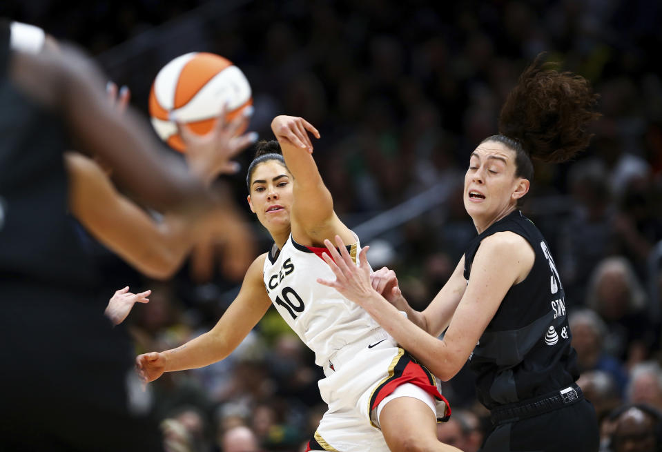 Las Vegas Aces guard Kelsey Plum (10) passes around Seattle Storm forward Breanna Stewart during the first half in Game 3 of a WNBA basketball semifinal playoff series Sunday, Sept. 4, 2022, in Seattle. (AP Photo/Lindsey Wasson)