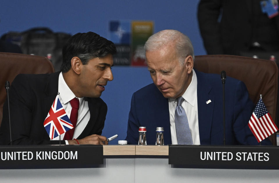 FILE - Britain's Prime Minister Rishi Sunak, left, and U.S. President Joe Biden speak at the start of the meeting of the North Atlantic Council (NAC) during the NATO Summit in Vilnius, Lithuania, July 11, 2023. U.S. and British militaries are bombing more than a dozen sites used by the Iranian-backed Houthis in Yemen, in a massive retaliatory strike using warship-launched Tomahawk missiles. (Paul Ellis/Pool Photo via AP, File)