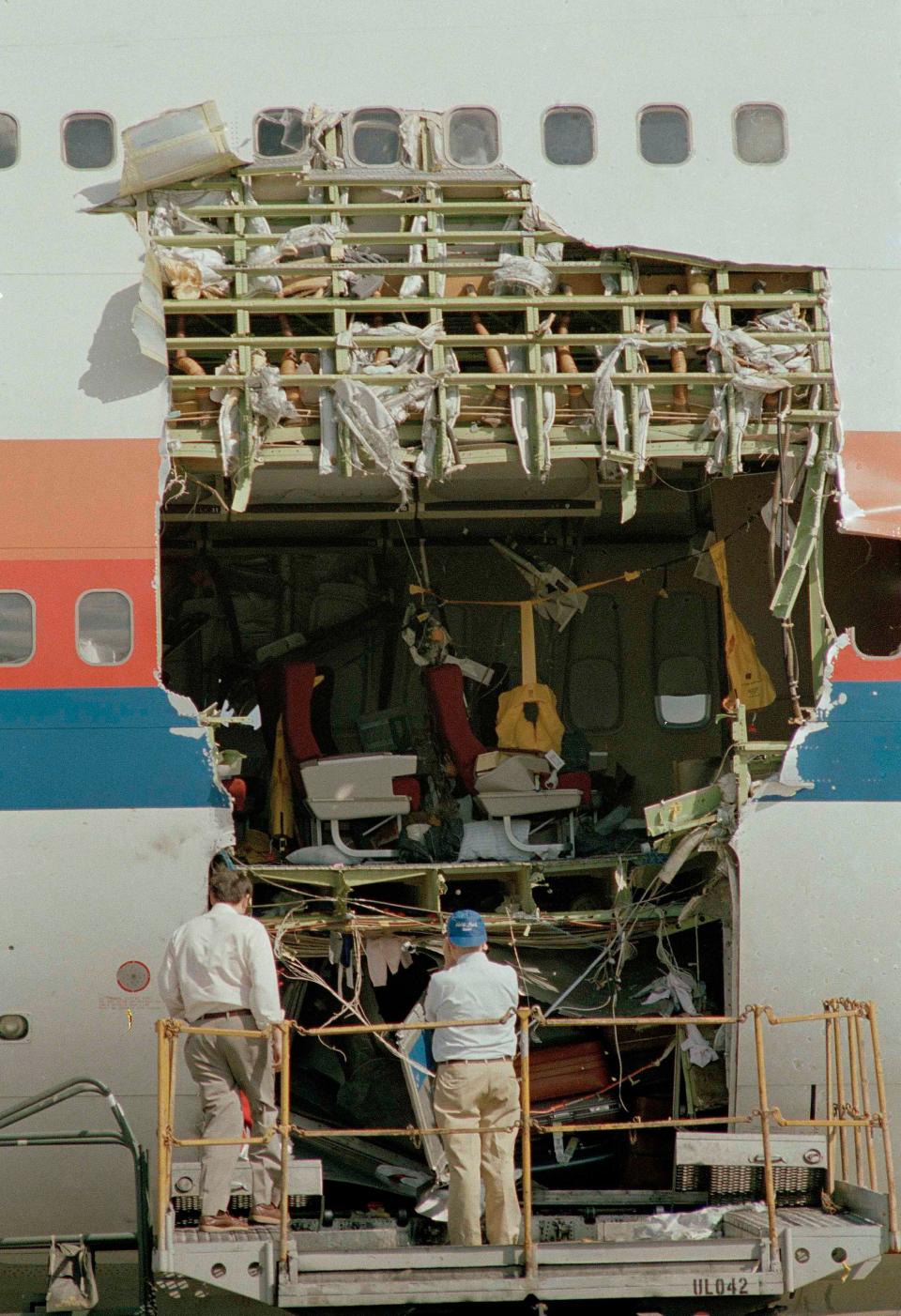 Two inspectors look at the severely damaged United Airlines Flight 811 at Honolulu Airport, Feb. 26, 1989.