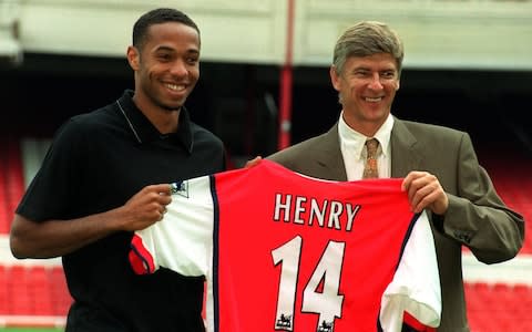 Thierry Henry and Arsene Wenger pose for the cameras on the day Henry signed for Arsenal in 1999 - Credit: PA