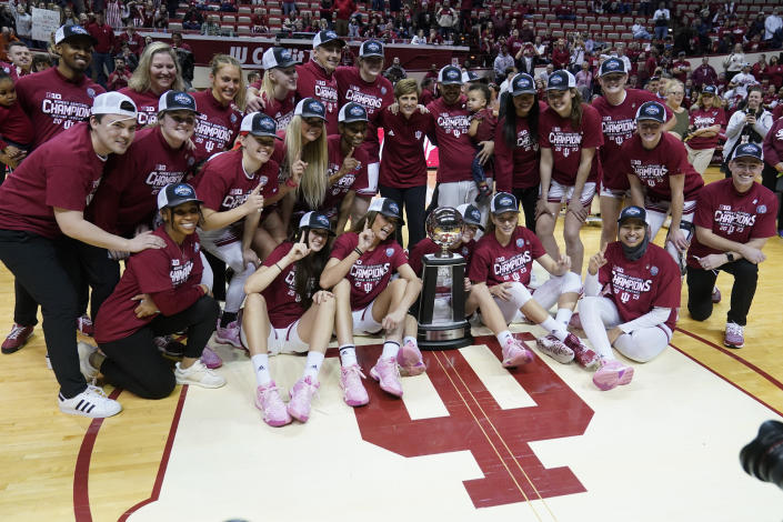 The Indiana team celebrates with the trophy after defeating Purdue in an NCAA college basketball game, Sunday, Feb. 19, 2023, in Bloomington, Ind. (AP Photo/Darron Cummings)