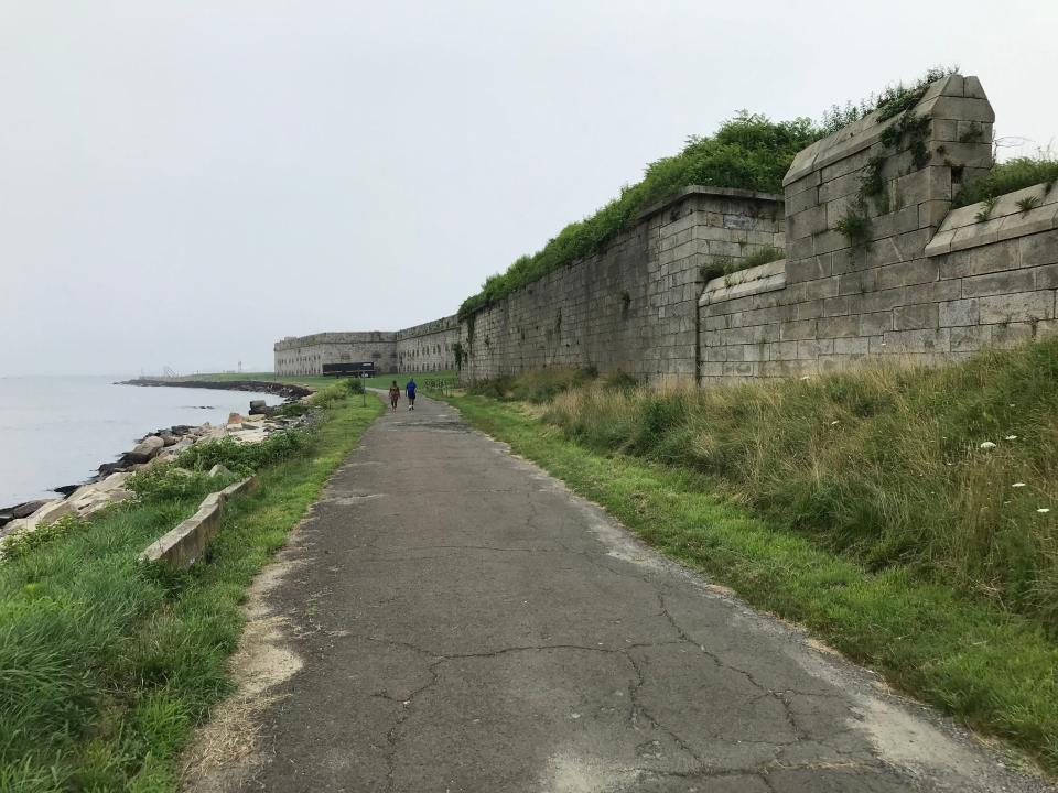 A portion of the Fort Adams Bay Walk is a paved road that runs parallel to the west wall of the former coastal defense installation, completed in 1857.