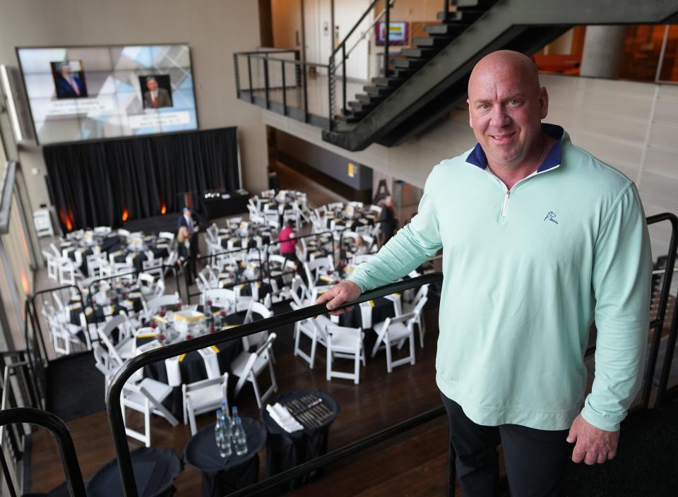 Owner Steve Short stands in front of the tables for the evening at an event catered by Atlasta Catering.