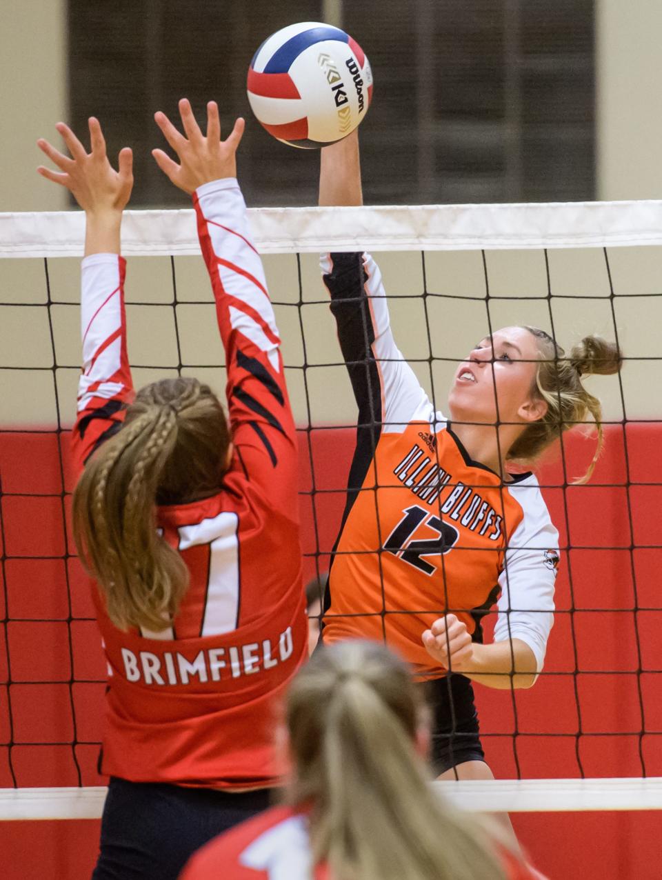 Illini Bluffs' Annabelle Fortin (12) spikes the ball against Brimfield's Josie Wiewel in the second set of their volleyball match Thursday, Sept. 21, 2023 at Brimfield High School. Illini Bluffs defeated Brimfield in three sets 17-25, 25-19 and 25-18.
