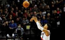 Feb 19, 2016; Portland, OR, USA; Portland Trail Blazers guard Damian Lillard (0) hits a three point shot during the third quarter of the game against the Golden State Warriors at the Moda Center at the Rose Quarter. Lillard scored 51 points as the Blazers won the game 137-105. Mandatory Credit: Steve Dykes-USA TODAY Sports