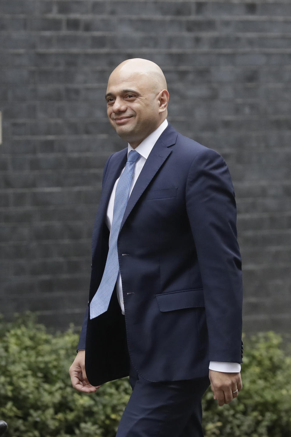 British lawmaker Sajid Javid Chancellor of the Exchequer walks along Downing Street in London, Thursday, Feb. 13, 2020. British Prime Minister Boris Johnson shook up his government on Thursday, firing and appointing ministers to key Cabinet posts. Johnson was aiming to tighten his grip on government after winning a big parliamentary majority in December's election. That victory allowed Johnson to take Britain out of the European Union in January. (AP Photo/Matt Dunham)