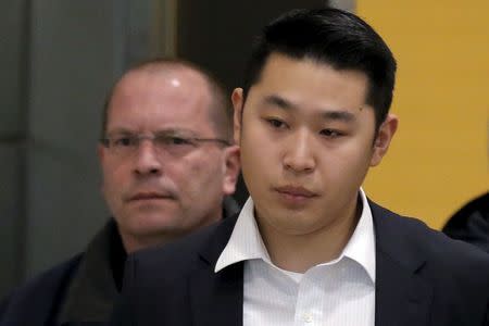 New York City Police officer Peter Liang is led from the court room at the Brooklyn Supreme court in New York, in this file photo taken February 11, 2016. REUTERS/Brendan McDermid/Files