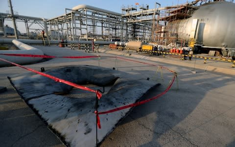 A metal part of a damaged tank at the damaged site of Saudi Aramco oil facility in Abqaiq - Credit: REUTERS/Hamad l Mohammed
