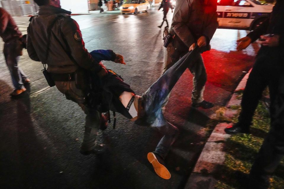 Israeli police detain a man during a demonstration calling for new elections, frustrated with the government's failure to bring all hostages held in the Gaza Strip by the Hamas militant group and demanding a ceasfire in Tel Aviv, Israel, Saturday, Jan. 27, 2024. (AP Photo/Ariel Schalit)