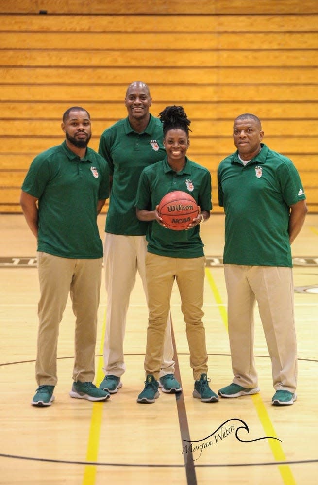 Bryson Smith, left, poses with fellow coaches Rodney Dobard, Kay Saunders and Chris Martin.