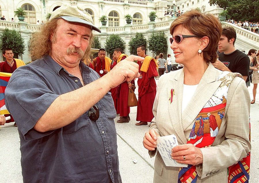 Musician David Crosby speaks with Nancy Pelosi during a rally of Tibet supporters in 1998. (Photo Tim Sloan /AFP via Getty Images)