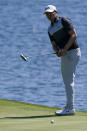 Matthew Fitzpatrick of England watches his putt on the 18th hole during the first round of the The Players Championship golf tournament Thursday, March 11, 2021, in Ponte Vedra Beach, Fla. (AP Photo/John Raoux)