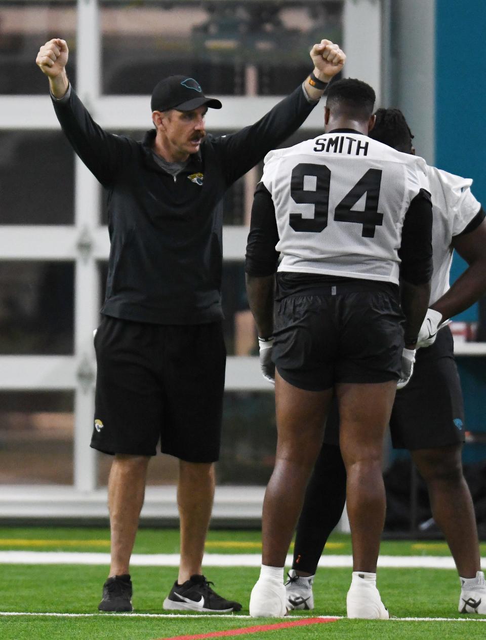 Jacksonville Jaguars defensive coordinator Ryan Nielsen talks with Jaguars defensive lineman Maason Smith (94) during Friday's rookie minicamp. The Jacksonville Jaguars held their first day of rookie minicamp inside the covered field at the Jaguars performance facility in Jacksonville, Florida Friday, May 10, 2024.