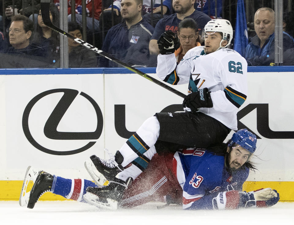 San Jose Sharks right wing Kevin Labanc (62) falls over New York Rangers center Mika Zibanejad (93) during the second period of an NHL hockey game, Saturday, Feb. 22, 2020, at Madison Square Garden in New York. (AP Photo/Mary Altaffer)