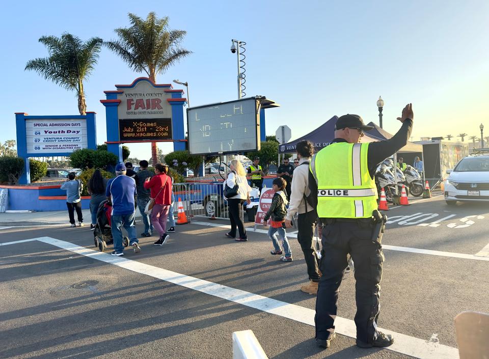 Ventura Police Officer Keith Therrien directs traffic at the entrance of the Ventura County Fair on Friday.